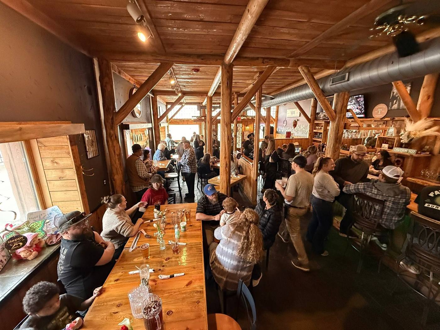 The full timber-frame dining room on a busy night