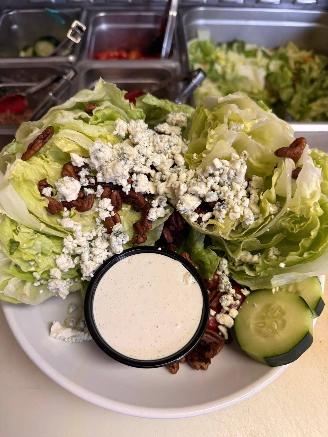 Wedge salad with blue cheese, candied pecans, and cucumber